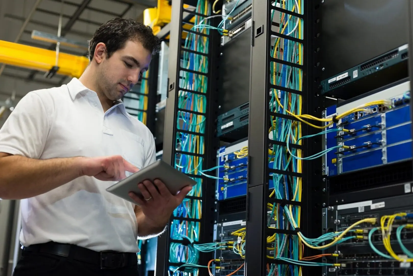 A datacenter manager checking the datacenter equipment racks.