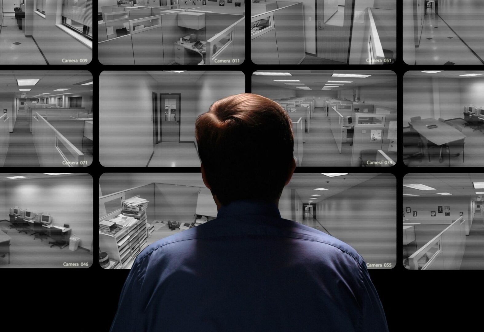 Man In Control Room Monitoring Multiple Cctv Footage